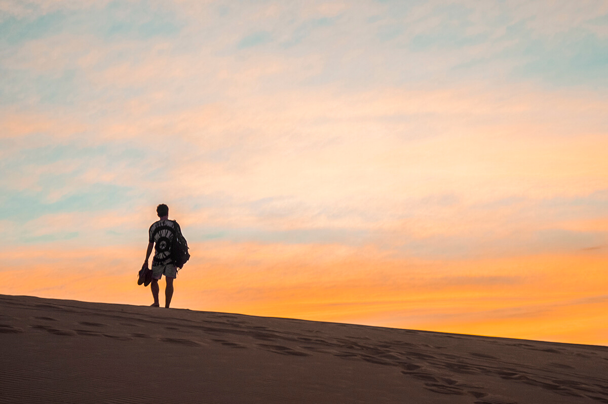 backpacking southeast asia - sand dunes man